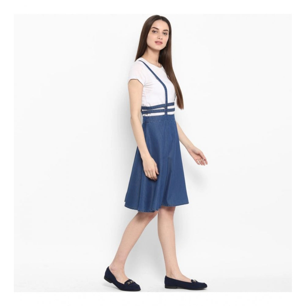 A woman in a blue denim dress with short sleeves and below-the-knee length, styled with white strap sandals