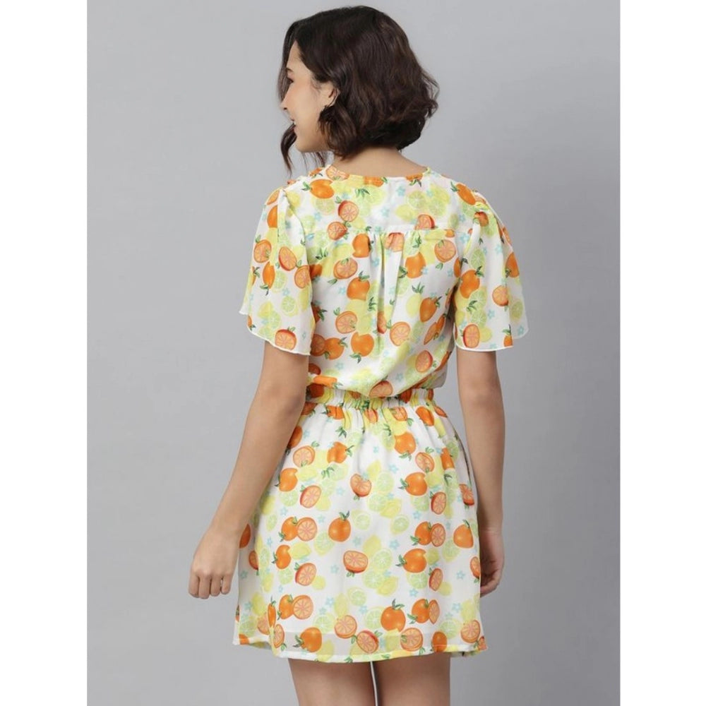 A woman in a blue outfit wearing a flutter above knee dress with orange and yellow print