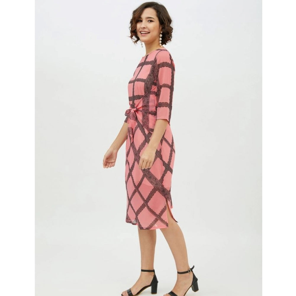 A woman in a sleeveless pink dress with checkered pattern