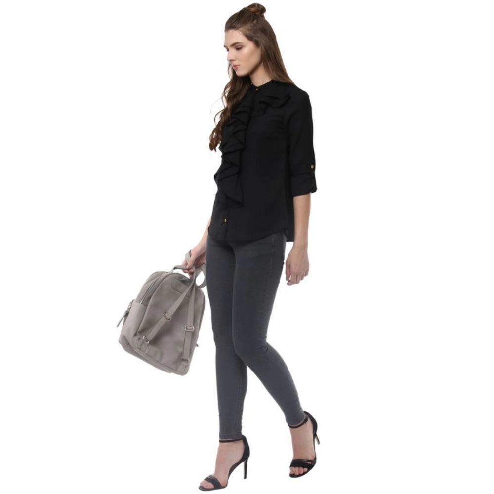 Black polyester ruffled long sleeves top with closed neck, fashionable women's clothing on hanger