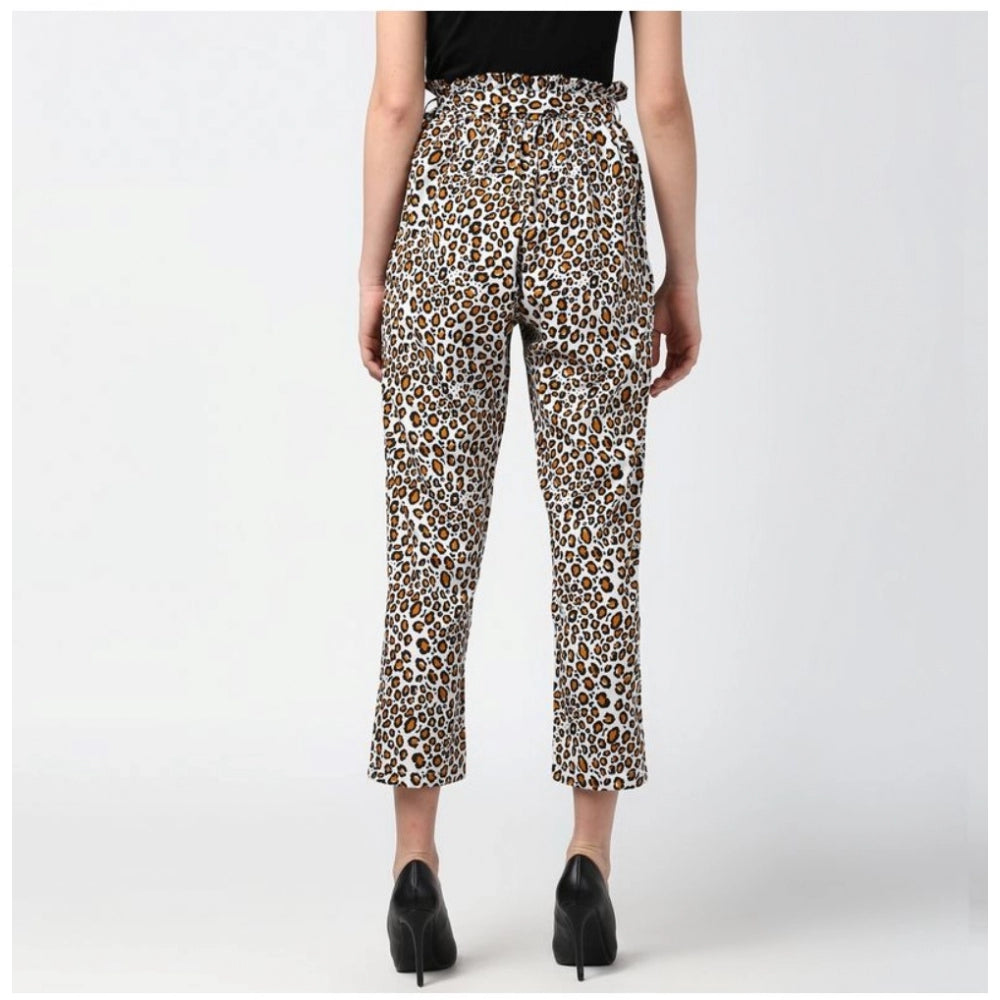 White-Yellow animal print polyester elastic trousers for women, vibrant pattern on display