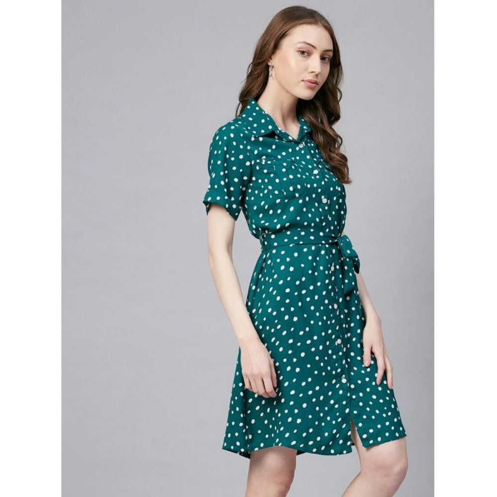 A blue and white polka dot womens polyester dress with short sleeves and an above-knee length