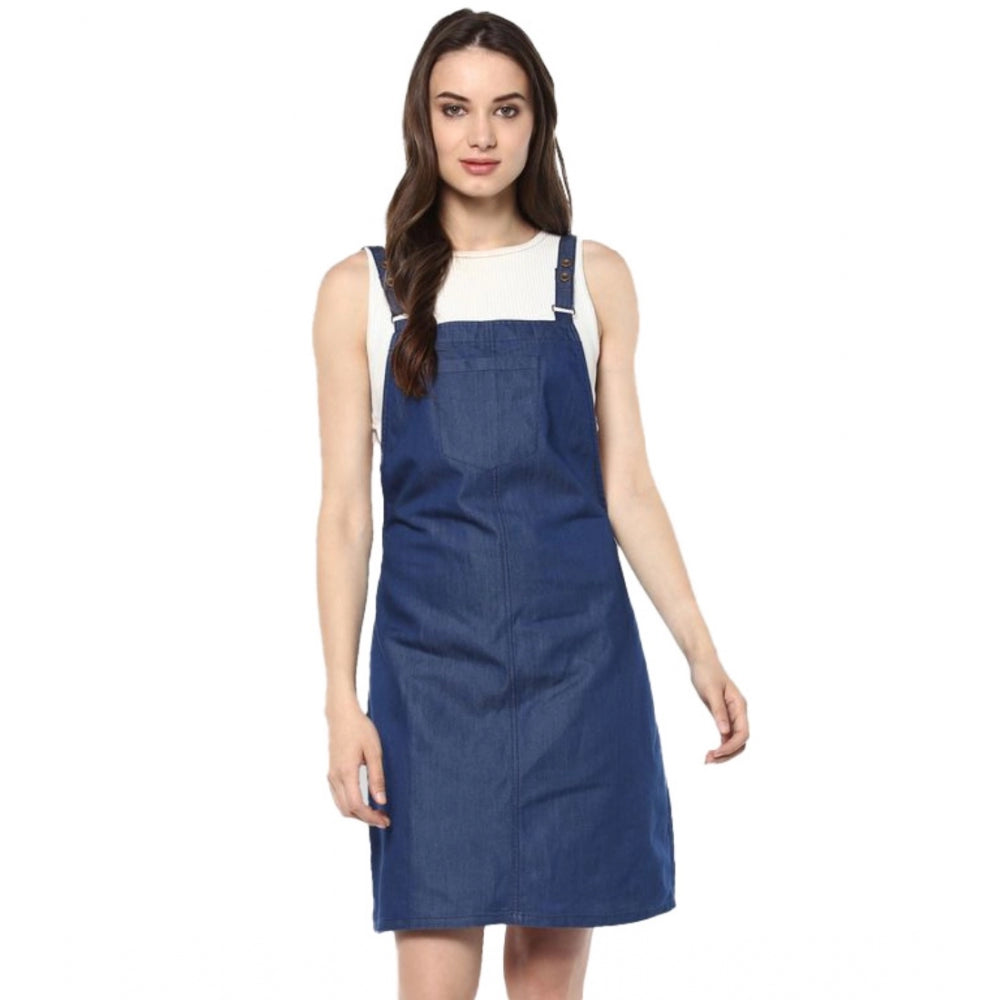 Blue denim dress with above knee length, shoulder straps, and solid color. Suggests casual wear