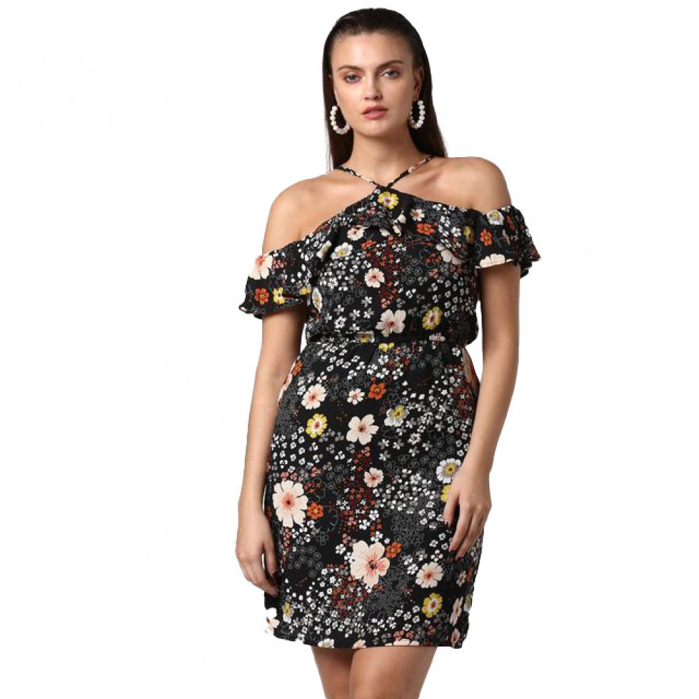 A woman modeling a black cold shoulder dress with floral print