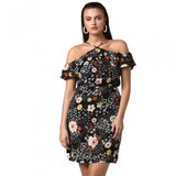 A woman modeling a black cold shoulder dress with floral print