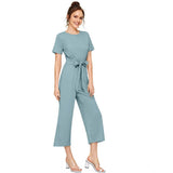 Light blue jumpsuit with cap sleeves and solid round neck, knitted fabric