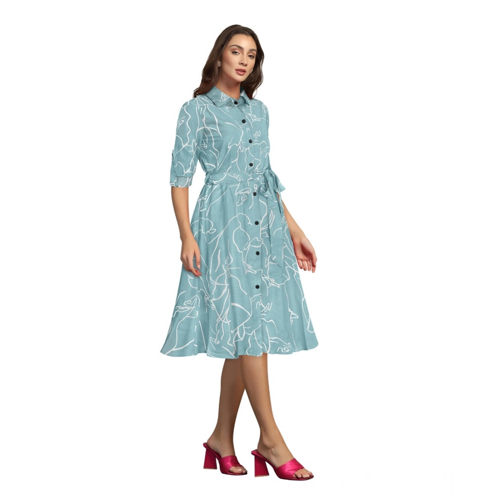 Women's short-sleeved dress with a floral print in shades of blue, green, and pink on a pista fabric background