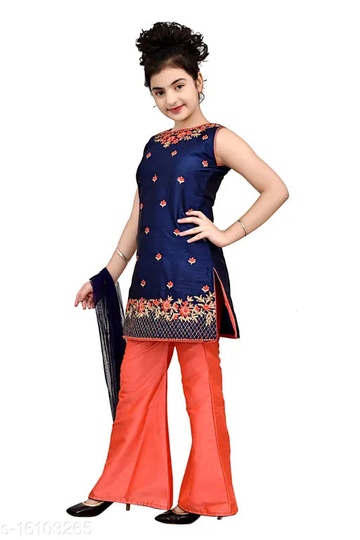 A woman in a blue and red dress with a flared skirt and sleeves, posing against a white background