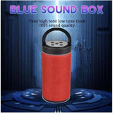 A small red portable wireless bluetooth speaker with a thick, sturdy handle and a visible tone control knob