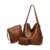 Brown PU leather medium shoulder zipper handbag with adjustable sling strap and two handle options