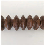Brown wood wheel roller scraping tool for trigger point muscle relief, gua sha therapy tool