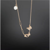 Gold-plated stainless steel butterfly pendant on delicate chain, close-up view