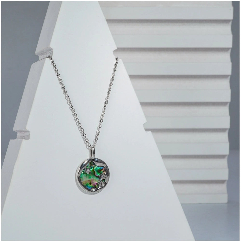 Stainless steel galaxy pendent on delicate silver-plated chain, intricate design with star motif