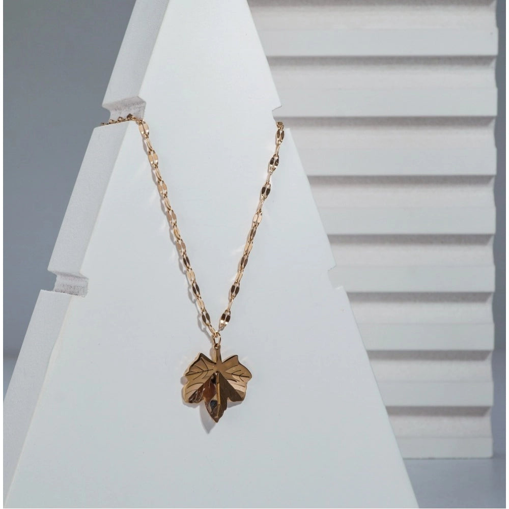 Gold-plated stainless steel leaf pendant on delicate chain, close-up view of women's jewelry accessory