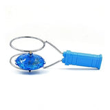 Multi-colored plastic magnetic gyro wheel toy, spinning with flashing lights on a play mat