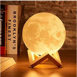Multicolor plastic 3D moon night lamp with varying hues, illuminating bedroom decor