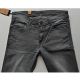 Grey cotton blended tapered jeans for men on model, solid pattern, mid-rise with button closure