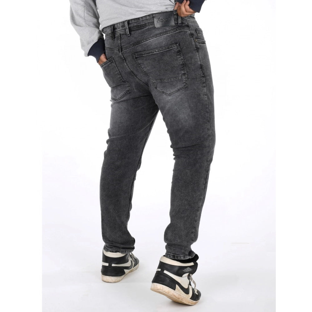 Grey cotton-blend plus size men's solid jeans on model, mid-rise style with button closure
