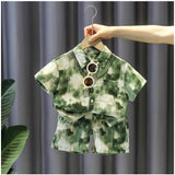 Green Lycra printed boy's casual wear shirt & shorts set, short sleeve design on display