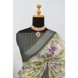 Green linen digital print saree with unstitched blouse, vibrant floral pattern on a traditional backdrop