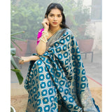Sky blue silk printed saree with unstitched blouse, vibrant floral patterns on display