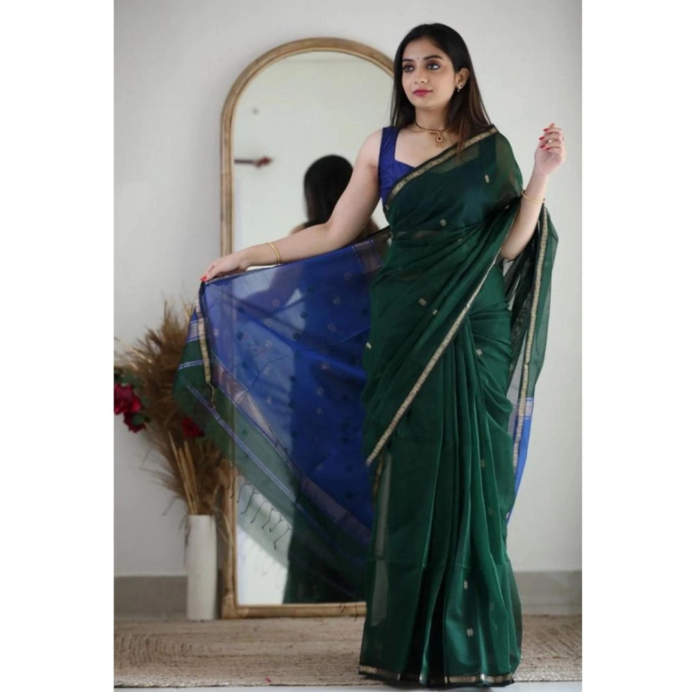 Green cotton printed saree with unstitched blouse, vibrant Indian fashion wear on mannequin