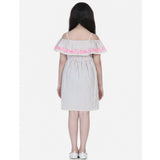 Beige-pink cotton printed sleeveless shoulder straps dress for girls, vibrant summer fashion on model