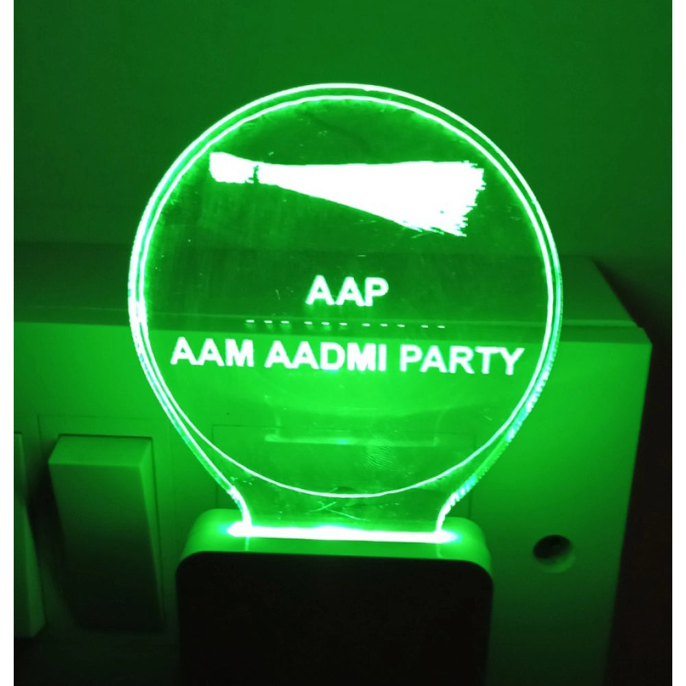 The image displays an AAP AC adapter with a night lamp feature, as indicated by the visible green bulb and the illuminated text reading "AAP ADMI PARTY." The light is turned on