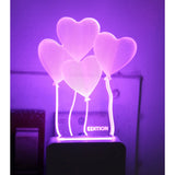 A purple night lamp shaped like four heart balloons with a white LED bulb inside