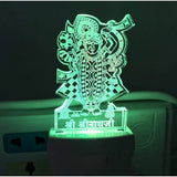 Green and orange glass night lamp with figure of a deity