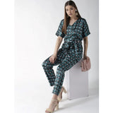 Green polyester polka dot jumpsuit with half sleeves, belted waist, and knee-length pants