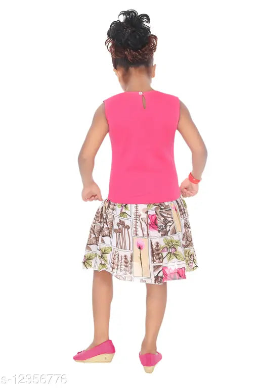 Girl in pink tank top and patterned skirt standing on white surface