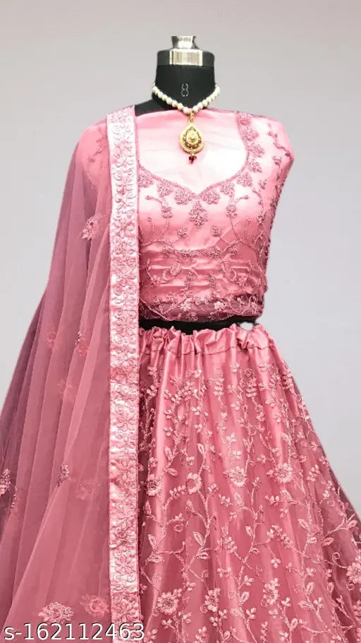 Pink net lehenga choli set for women and girls, featuring traditional semi-stitched design with embroidery. Includes free size lehenga (waist 42 m, length 42 m), dupatta (length 2.5 m), and blouse piece. Perfect for regular occasions, parties, weddings, festivals, bridals, functions, trips, or as a gift. Indian-inspired ethnic wear with long flair