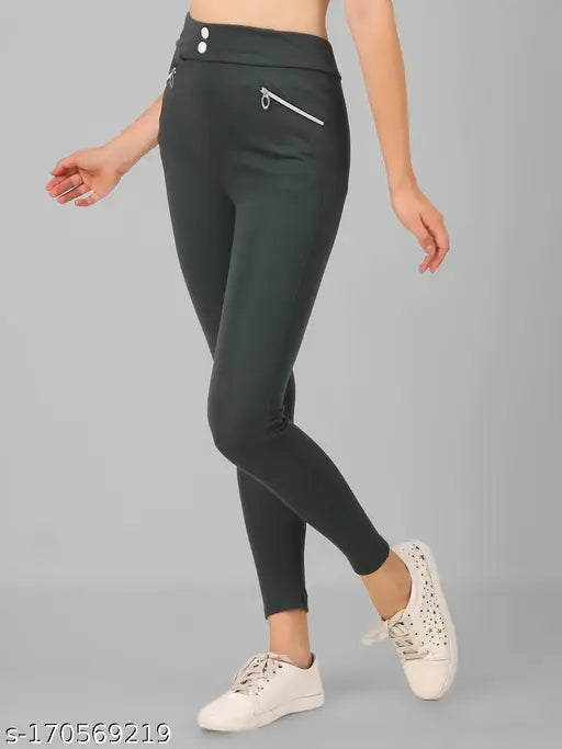 Solid green polyester stylish pocket jegging for women and girls, vibrant green pants on hanger with front pockets
