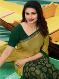 A woman in a vibrant green sari, detailed gold paisley designs on blouse, high neckline, and short sleeves