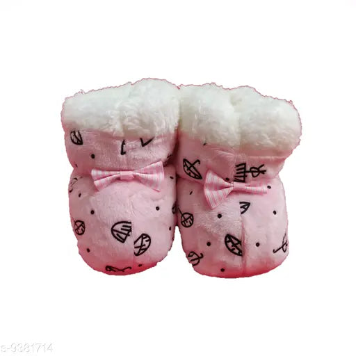 Pink and white fluffy baby booties with ribbon detail