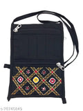 Black fabric sling handbag with colorful cross stitch detailing, zippered top, multiple card slots