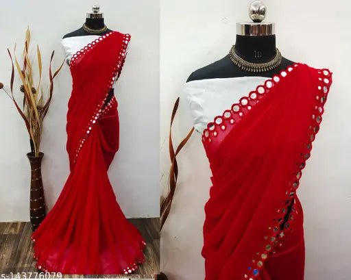 A red and gold traditional sari with mirror cutwork, displayed on a mannequin