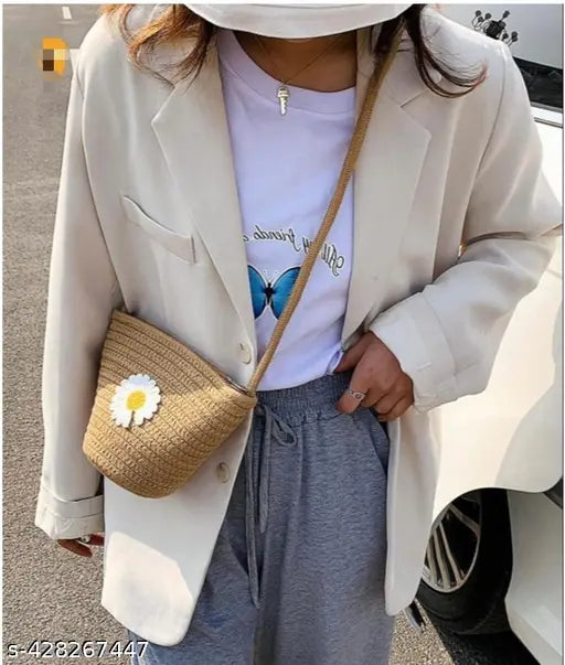 Tan jute sling bag with silver metal hardware and small floral embroidery detail, suitable for holding makeup or personal items
