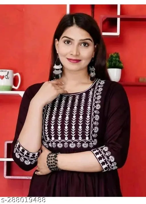 A woman wearing a purple embellished kurta with embroidered details