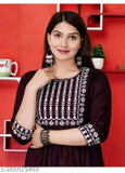 A woman wearing a purple embellished kurta with embroidered details
