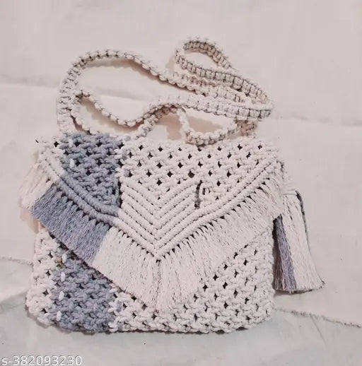 The image shows a handcrafted, bohemian-style crossbody bag. It appears to be made of a textured fabric with intricate macrame patterns and has a flap closure. The bag is described as eco-friendly, sustainable, and unique, making it a statement piece suitable for festivals or as a gift