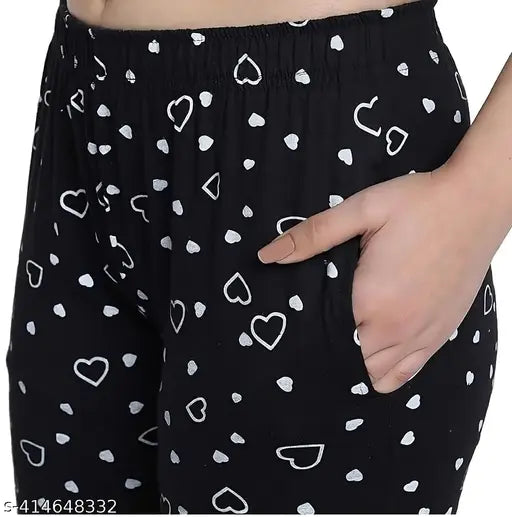 A pair of women's shorts with a floral print, black background and heart accents