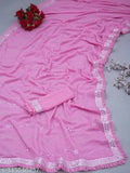 Pink and white floral embroidered saree with tassels, laid out flat