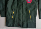 Green military jacket with epaulettes and gold zippers
