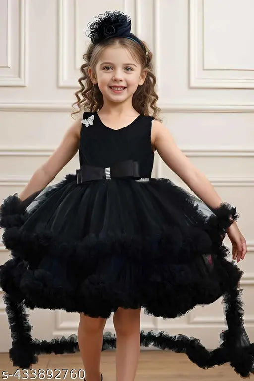 Black ruffled tulle party dress, with thin black straps and bow in back
