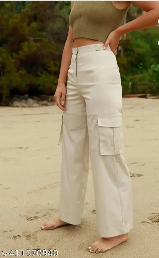Woman in cream cargo pants with four pockets on a sandy beach