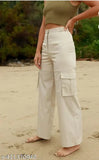 Woman in cream cargo pants with four pockets on a sandy beach