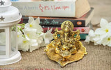 Golden oxide metal Lord Ganesh figurine on leaf with diya (11x9.5x7 cm), ideal for puja or home decor, symbolizing positive energy and good start, popular religious gift from India