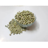 Microgreen seeds in clear bowl with pea variety identification label